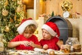 Santa kids making cookie. Funny children chefs in santa hats prepare holiday food. Two chldren in santa hats and aprons Royalty Free Stock Photo