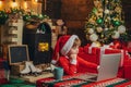 Santa little helper. Little Santa Claus helper elf with a magic gift for Christmas. Santa boy celebrate christmas at Royalty Free Stock Photo