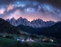 Santa Maddalena and acrhed Milky Way at night in summer in Italy