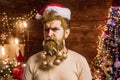 Santa man posing on vintage wooden background. Theme Christmas holidays and winter new year. New year fashion portrait. Royalty Free Stock Photo