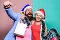 Santa man and woman with tinsel. christmas shopping sales. winter holidays celebrate together. happy new year party Royalty Free Stock Photo