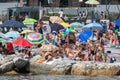 Crowds of tourists crowded on the beach in summer during the period of the pandemic due to Covid. Crowded people at the seaside