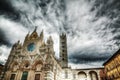 Santa Maria Assunta cathedral in Siena under a dramatic sky