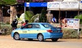 Two men talk near stationary taxi cab, in Santa Maria, Cape Verde