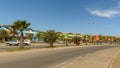 SANTA MARIA, CABO VERDE - NOVEMBER 29, 2017: street with palms and colored apartments across hotels in Santa Maria