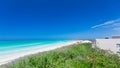 stunning, mesmerizing view of a white sand beach and tranquil,turquoise water on sunny gorgeous day