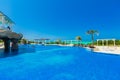 Gorgeous inviting view of Golden Tulip hotel swimming pool and grounds with people relaxing in background