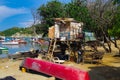 SANTA MARTA, COLOMBIA - OCTOBER 10, 2017: Outdoor view of many boats in the water and a pink boat in the sand in a Royalty Free Stock Photo