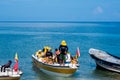 SANTA MARTA, COLOMBIA - OCTOBER 10, 2017: Unidentified tourists sailing in a boat in a caribean beach. Taganga, Colombia