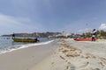 Two tourist guides holding a boat in rodadero beach in sunny day