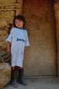 tribal kogi kid in front of their family home