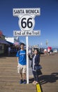 Santa Monica, California, USA 5/2/2015, asian couple pose at Route 66 sign Santa Monica Pier, end of famous Route 66 highway from