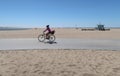 Santa Monica, California, USA 03.31.2017 bikepath on beach with cyclist and typical lifeguard tower in background Royalty Free Stock Photo