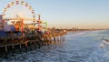 SANTA MONICA, LOS ANGELES CA USA - 19 DEC 2019: Classic ferris wheel in amusement park on pier. California summertime beach