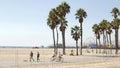 SANTA MONICA, LOS ANGELES CA USA - 28 OCT 2019: California summertime beach aesthetic, people walking and ride cycles on bicycle Royalty Free Stock Photo