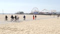 SANTA MONICA, LOS ANGELES CA USA - 28 OCT 2019: California summertime beach aesthetic, people walking and ride cycles on bicycle