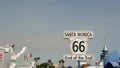 SANTA MONICA, LOS ANGELES, USA - 28 OCT 2019: Historic route 66, famous vintage california trip symbol. Pier of pacific ocean