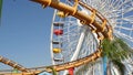 SANTA MONICA, LOS ANGELES, USA - 28 OCT 2019: Iconic colorful retro ferris wheel, roller coaster in amusement park. Famous classic