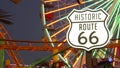 SANTA MONICA, LOS ANGELES, USA - 28 OCT 2019: Iconic road sign glowing, historic route 66. Famous california symbol, pier of Royalty Free Stock Photo