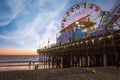 Santa Monica Pier and its amusement park off a coast in California at dusk Royalty Free Stock Photo