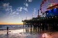 Santa Monica Pier and its amusement park off a coast in California at dusk Royalty Free Stock Photo