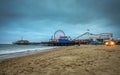 Santa Monica Pier with many visitors at a cloudy evening, Los Angeles