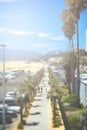 Vertical shot of a sunny road with palm trees in Santa Monica, USA