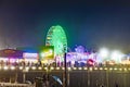 people enjoy the ocean park at Santa Monica pier by night Royalty Free Stock Photo