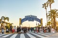 people have fun entering the pier to the amusement area pacific park on the pier of Santa Monica by night