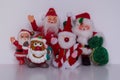 Santa Ornaments Standing Close Together Facing the Camera While Waving