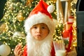 Santa picking cookie and glass of milk at home. Santa child eating cookies and drinking milk. Happy New Year. Greeting Royalty Free Stock Photo