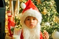 Santa picking cookie and glass of milk at home. Santa child eating cookies and drinking milk. Happy New Year. Greeting Royalty Free Stock Photo