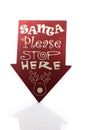 Santa Please Stop Here Sign Casting A Reflection