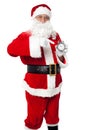 Santa pointing at an antique time piece Royalty Free Stock Photo