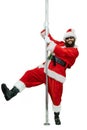 Santa is pole dancer. Lustful arabic young Santa Claus with black beard dances with pole on white background Royalty Free Stock Photo