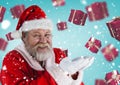 Santa pretending to hold digital generated christmas gifts Royalty Free Stock Photo