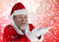 Santa pretending to hold digital generated snow Royalty Free Stock Photo