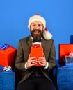 Santa in retro suit presents blue and red gifts. Royalty Free Stock Photo