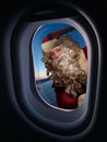 Santa glancing from Airplane window