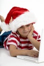 Santa's elve placing order on laptop Royalty Free Stock Photo