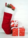 Santa`s red boot with New Year or Christmas gift boxes on white background. Copy space Royalty Free Stock Photo