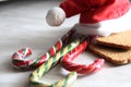 Santa`s red hat, three candy canes and two cookies. concept of Christmas and new year sweets. Christmas dwarf hat