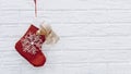 Santa`s red stocking. Concept of christmas or holiday. Red and white Christmas stocking, Santa Claus sock hanging from a