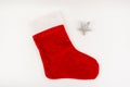 Santa`s red stocking isolated on white background together with a toy in the form of a star. Christmas or holiday concept Royalty Free Stock Photo