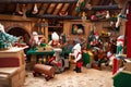 santa's workshop, with elves and toys in the background Royalty Free Stock Photo