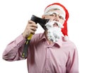 Santa shaving his beard with an axe