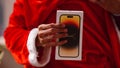 santa showing Iphone 14 pro in santa\'s hand gift iphone apple products new launch of apple 14 pro phone box