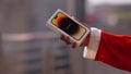 santa showing Iphone 14 pro in santa\'s hand gift iphone