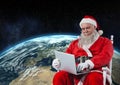Santa sitting on chair and using laptop Royalty Free Stock Photo