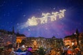 Santa in sled flying over Christmas night city Royalty Free Stock Photo